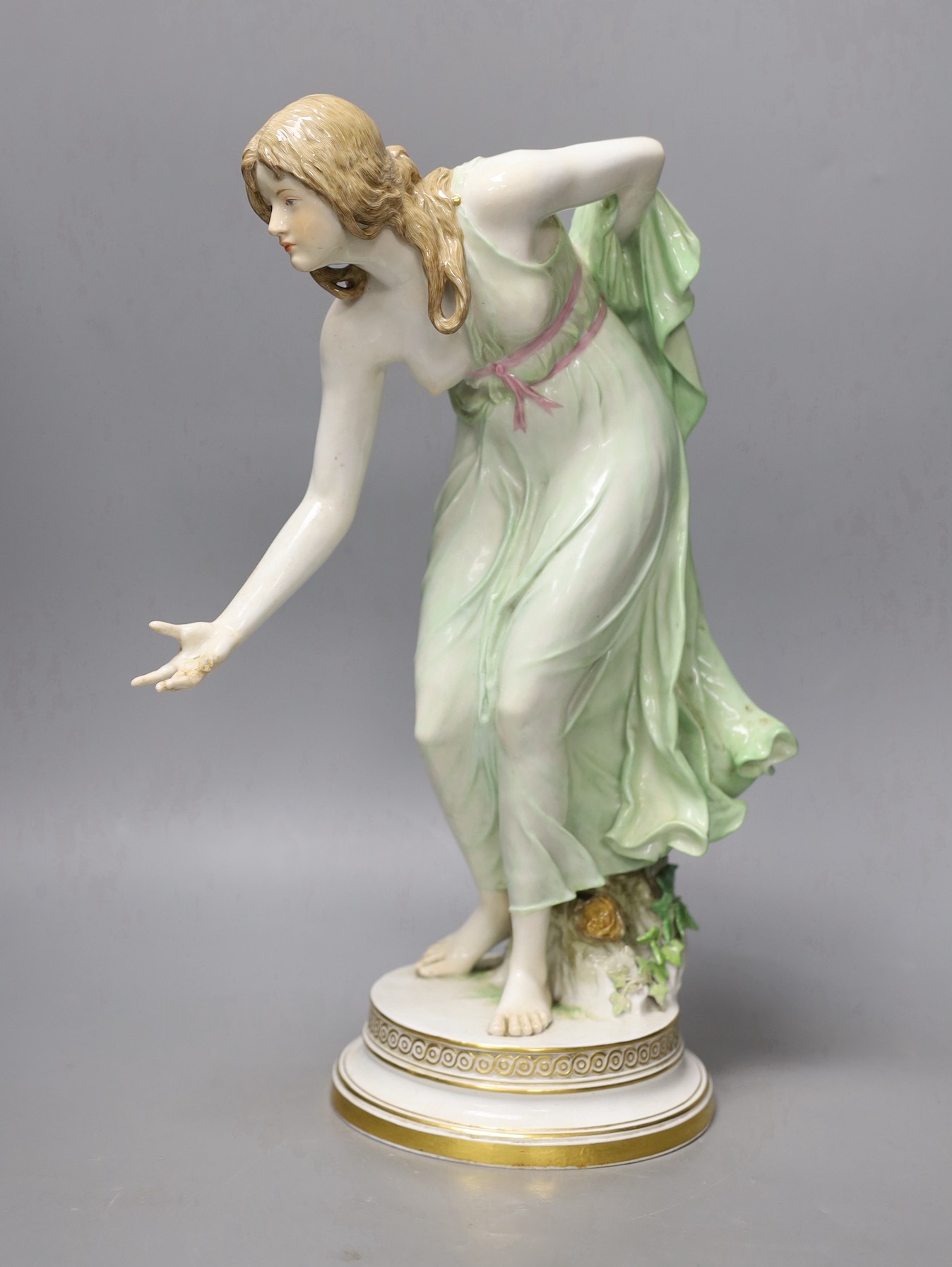 A Meissen Art Nouveau figurine of a young lady playing boules, early 20th century, modelled by Walter Schott, 37cm high